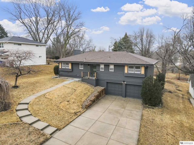 single story home featuring an attached garage, a shingled roof, a chimney, and concrete driveway