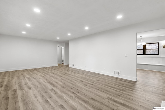 spare room with light wood-type flooring, visible vents, and recessed lighting