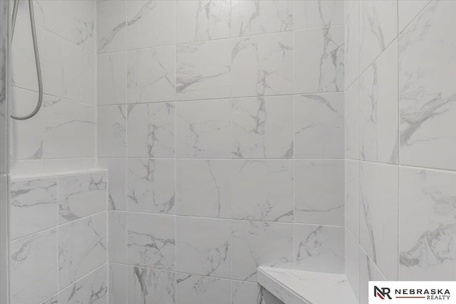 full bath with a tile shower