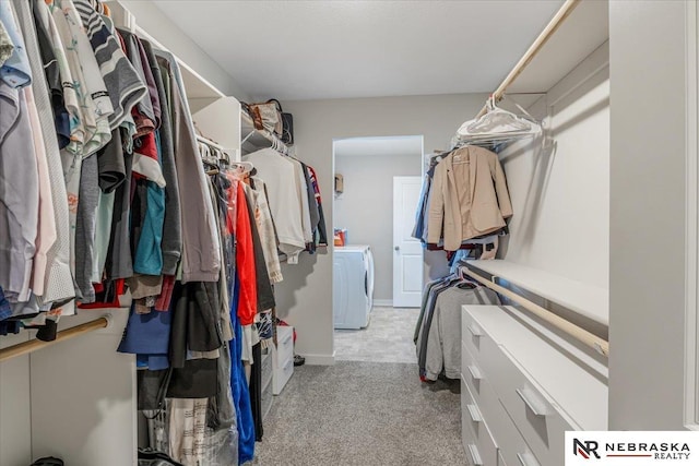 walk in closet featuring light carpet and washer / clothes dryer