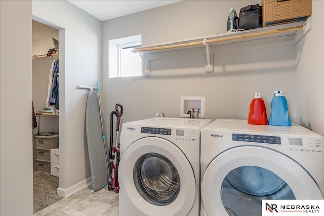 clothes washing area featuring laundry area, washer and clothes dryer, and baseboards