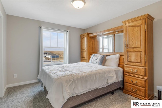 bedroom featuring baseboards and light colored carpet