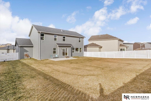 back of house with a patio area, a fenced backyard, and a yard