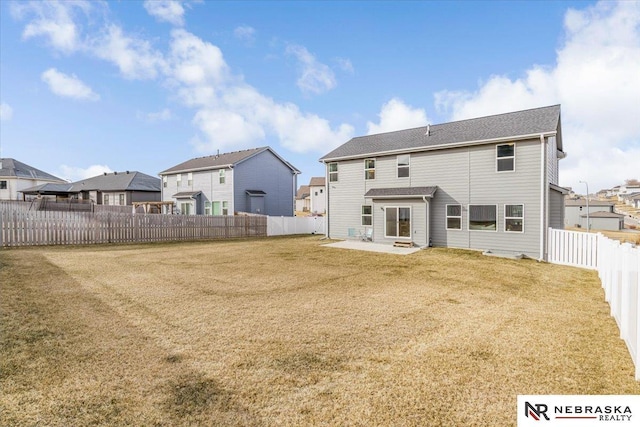 back of property with a yard, a patio, a fenced backyard, and a residential view