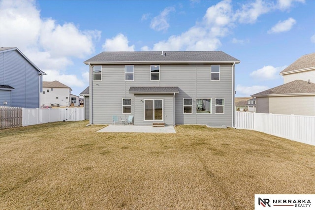 rear view of property featuring a lawn, a patio area, and a fenced backyard