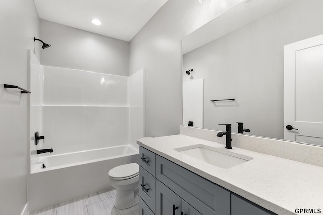 bathroom with shower / bathing tub combination, vanity, and toilet