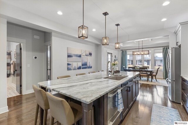 6919 Wildrye Rd, Lincoln, NE 68521 - kitchen featuring recessed lighting, dark wood finished floors, a sink, and freestanding refrigerator