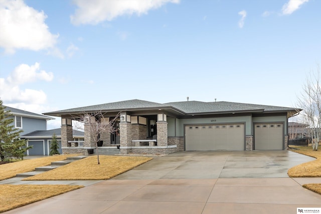 6919 Wildrye Rd, Lincoln, NE 68521 - prairie-style house with a garage, stone siding, and driveway