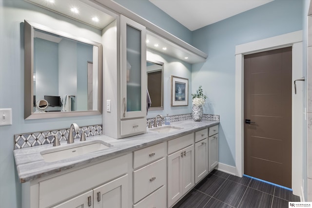 6919 Wildrye Rd, Lincoln, NE 68521 - bathroom with double vanity, baseboards, a sink, and tile patterned floors