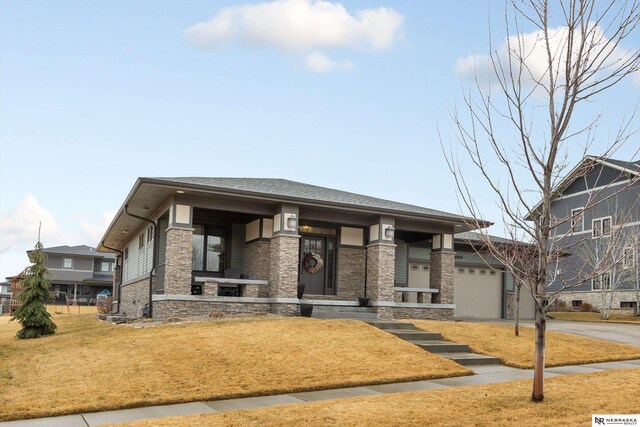 6919 Wildrye Rd, Lincoln, NE 68521 - prairie-style home featuring a garage, concrete driveway, a front lawn, and stone siding