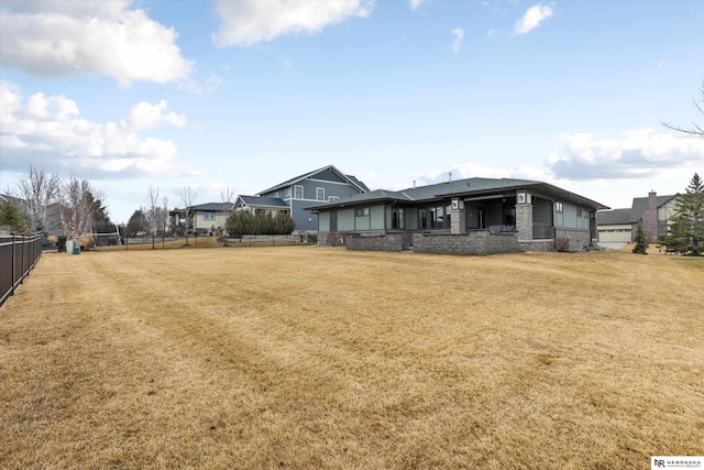 6919 Wildrye Rd, Lincoln, NE 68521 - exterior space with a front yard, stone siding, and fence