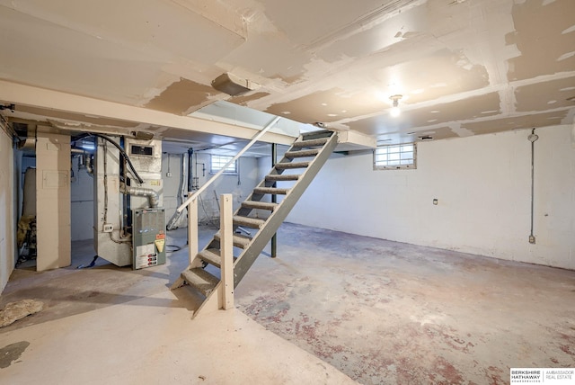 basement with stairway and heating unit