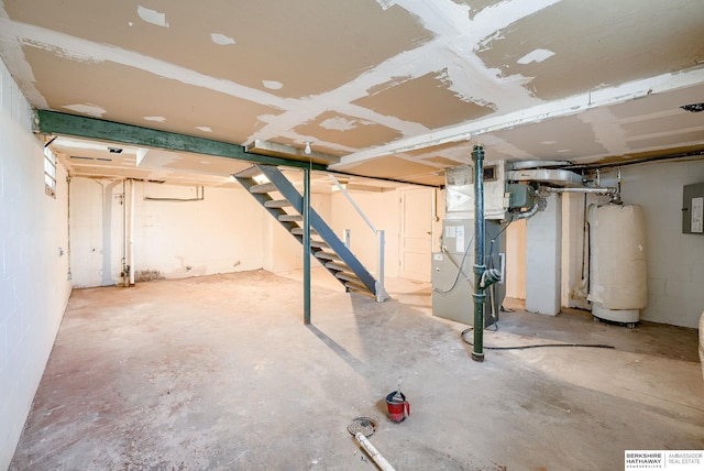 unfinished below grade area featuring gas water heater, heating unit, and stairs