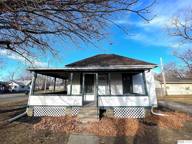 view of front of house with covered porch and roof with shingles