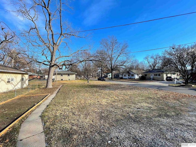 view of yard with a residential view and fence