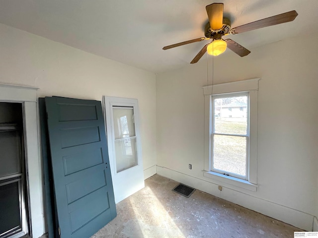 unfurnished room featuring a ceiling fan, visible vents, and unfinished concrete floors