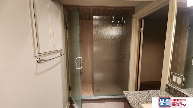 bathroom featuring a shower stall and vanity