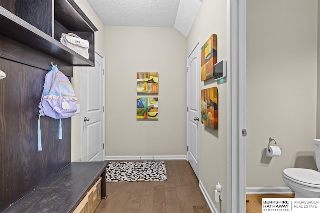 mudroom with dark wood-type flooring, a textured ceiling, and baseboards