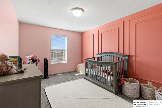 carpeted bedroom featuring a textured ceiling