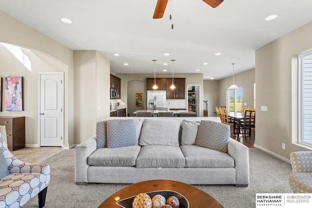 living room with light carpet, baseboards, a ceiling fan, and recessed lighting