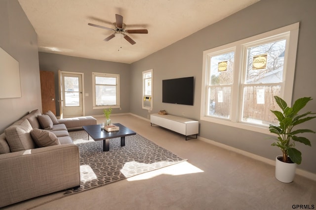 carpeted living area with a ceiling fan and baseboards