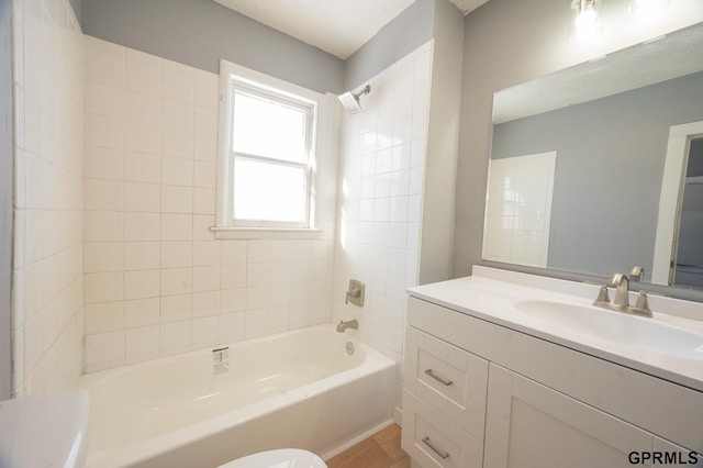 bathroom with shower / bath combination, vanity, and toilet