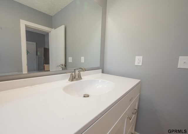 bathroom featuring vanity and a textured ceiling