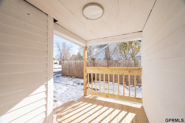 snow covered deck with fence