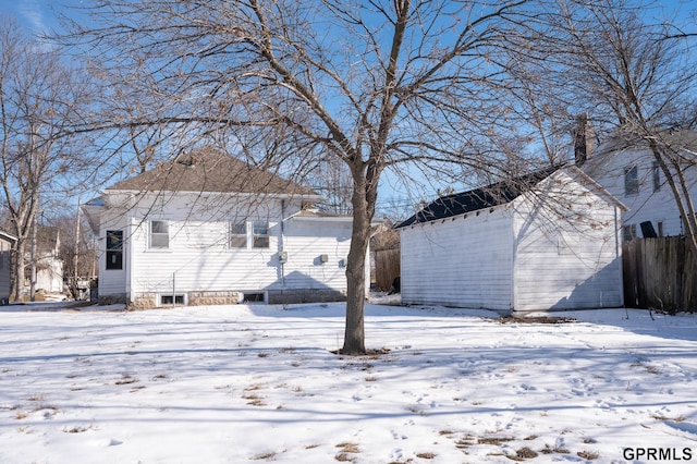 exterior space with an outbuilding, fence, and a storage shed