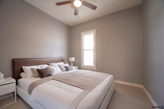 carpeted bedroom with baseboards and a ceiling fan