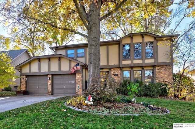 english style home featuring a garage, driveway, brick siding, and stucco siding