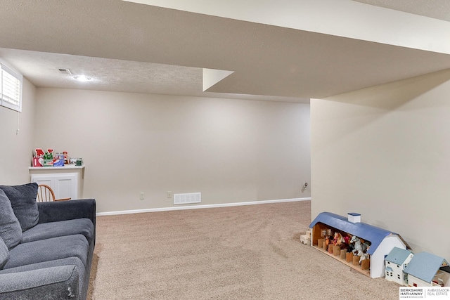 interior space featuring carpet floors, baseboards, visible vents, and a textured ceiling