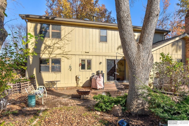 back of house with a patio area and a fire pit