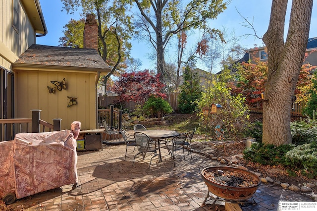 view of patio featuring fence and outdoor dining area