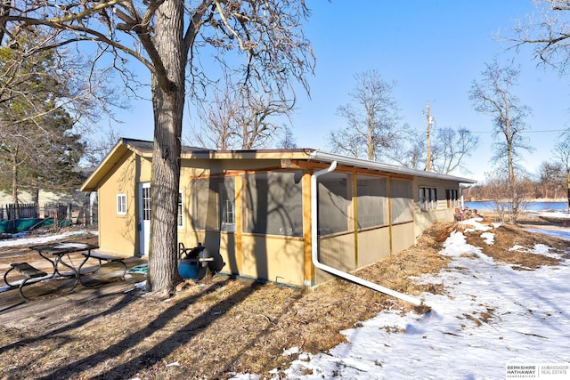 view of side of property featuring a sunroom