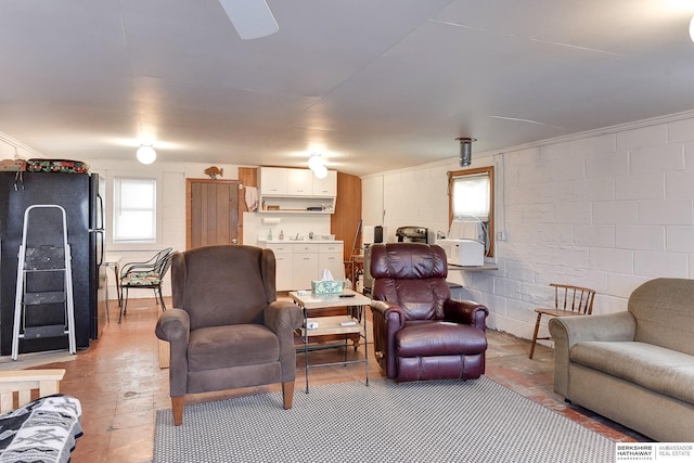 living room featuring concrete block wall