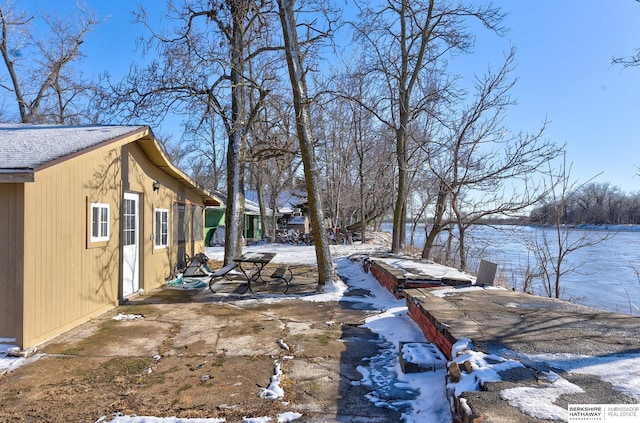 view of snowy exterior featuring a patio area