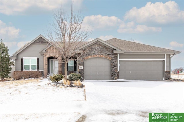 ranch-style home featuring roof with shingles and an attached garage