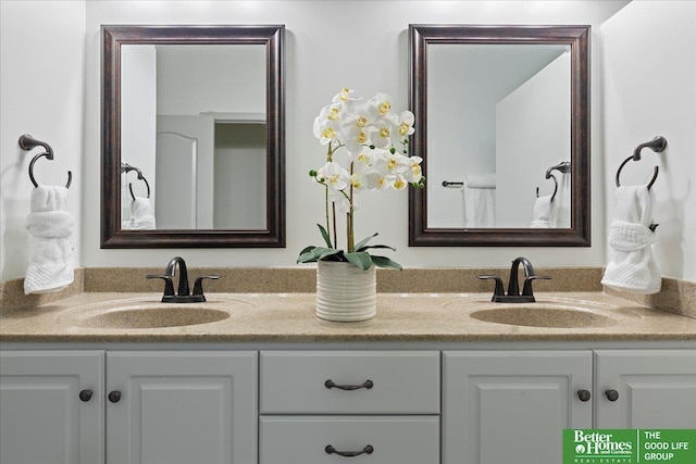 bathroom with a sink and double vanity