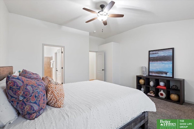 bedroom featuring a ceiling fan, carpet flooring, vaulted ceiling, and ensuite bath