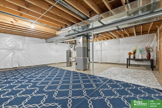 unfinished basement featuring heating unit and gas water heater