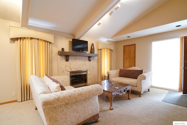 carpeted living area with vaulted ceiling with beams, rail lighting, baseboards, and a stone fireplace