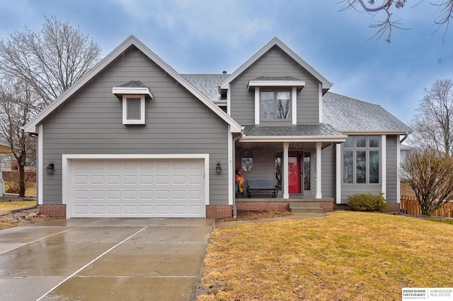 view of front facade with a garage, a shingled roof, concrete driveway, covered porch, and a front lawn