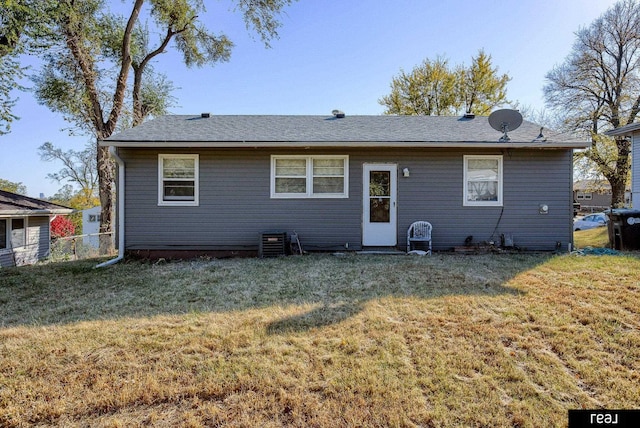 rear view of property with a lawn