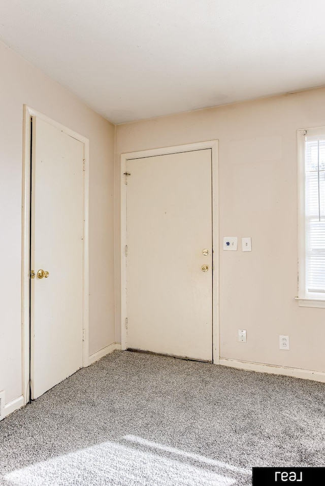 foyer entrance with carpet flooring