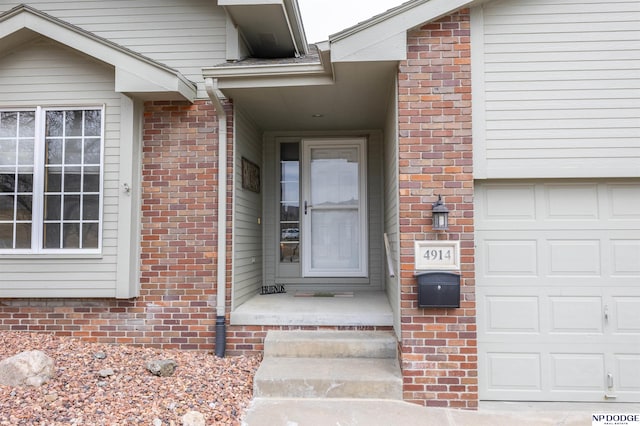 doorway to property with brick siding