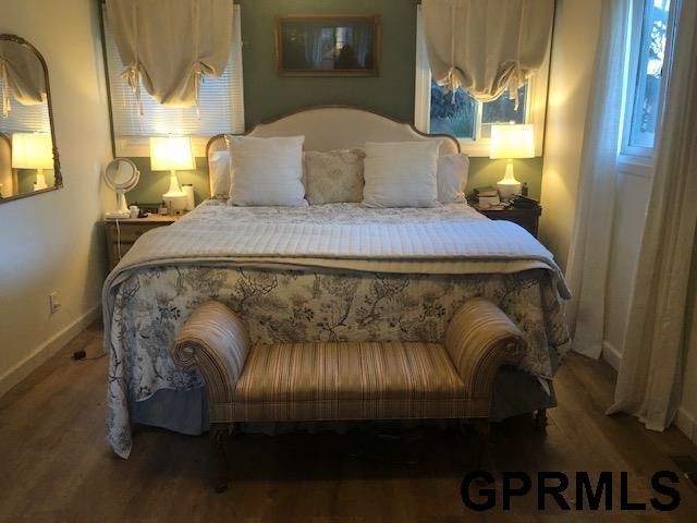 bedroom featuring baseboards and wood finished floors