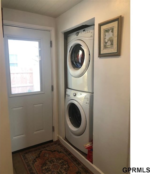 clothes washing area featuring laundry area and stacked washer / dryer