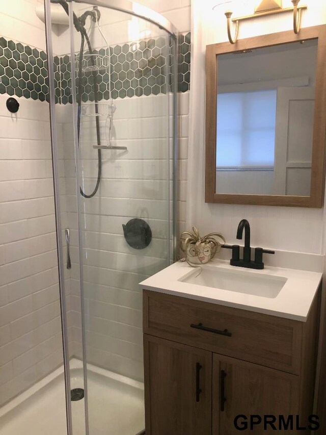 bathroom featuring a shower stall and vanity