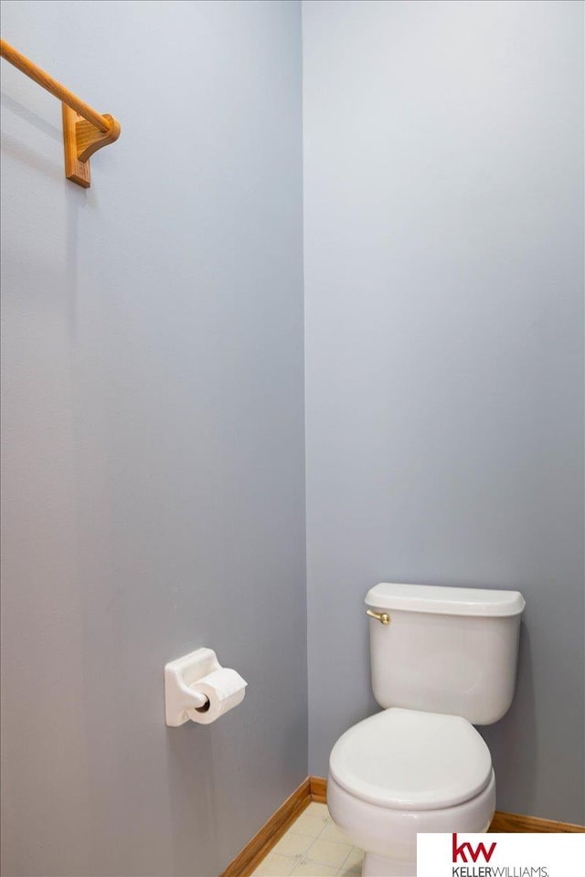 bathroom with toilet and baseboards